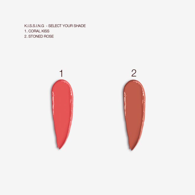 K.I.S.S.I.N.G Lipstick swatches Swatches of two satin-finish lipsticks in bright coral and nude reddish brown.
