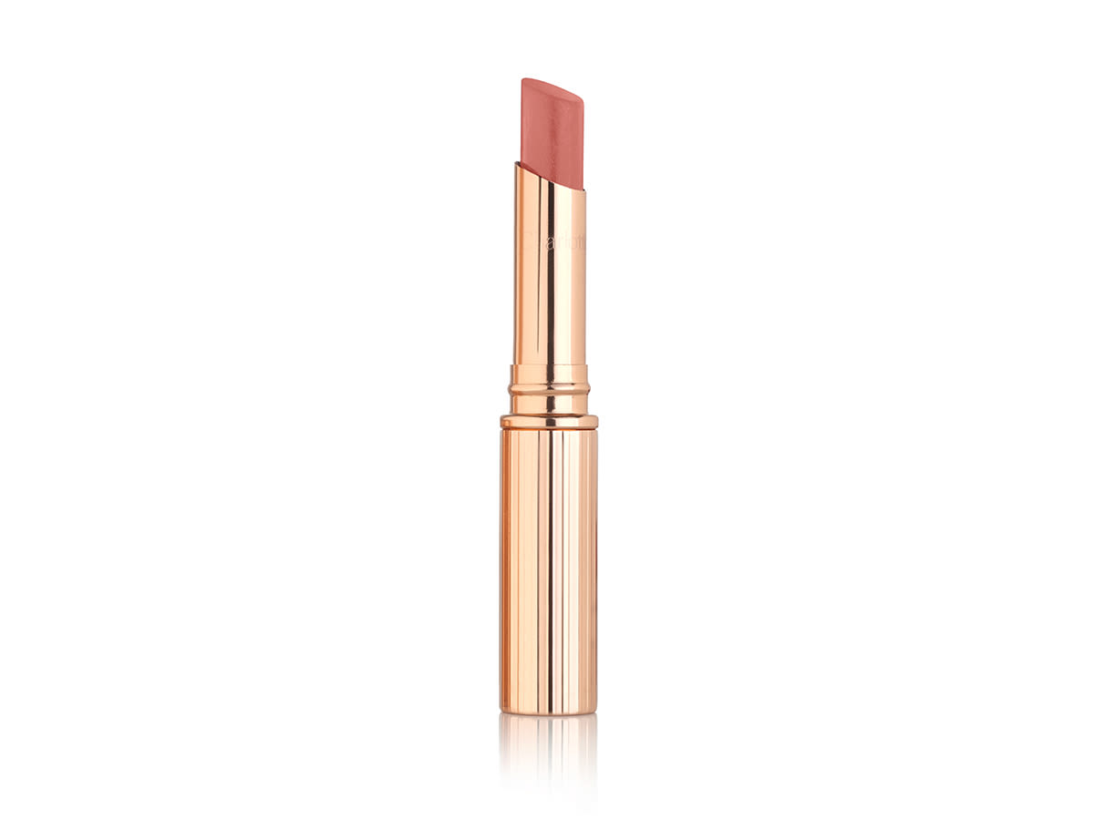 Pillow Talk Diamonds in Lucky Diamonds open An open sheer, glittering lipstick in a bronze coral-pink shade in golden packaging.
