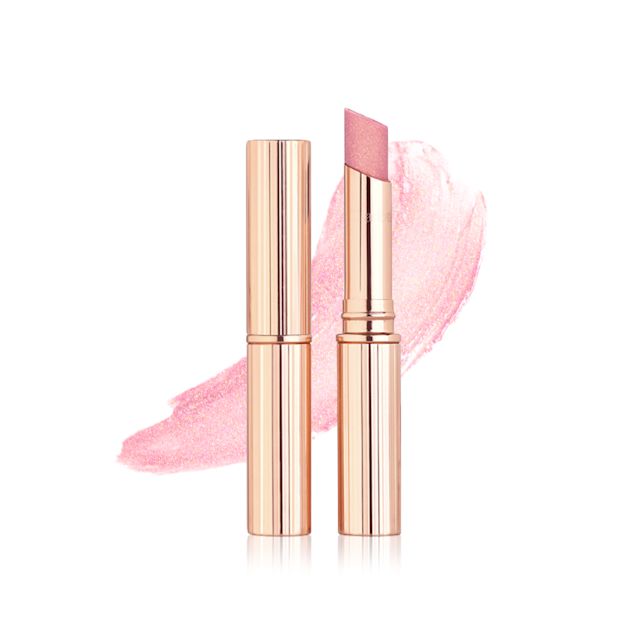 Pillow Talk Diamonds Lipstick with and without lid with swatch Two lipsticks, one with its lid and one without in a sheer, nude pink shimmery shade along with its swatch in the back.