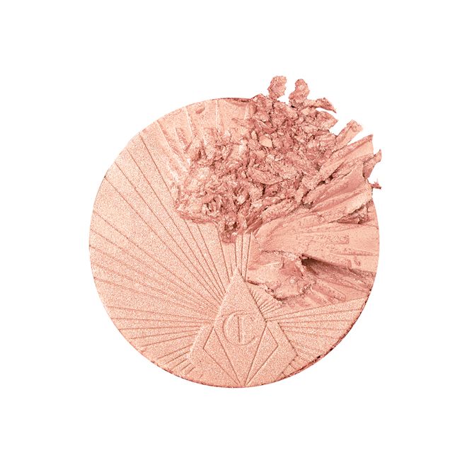 Hollywood Superstar Glow Highlighter swatch Swatch of a glowy powder highlighter in a light pinky beige shade.