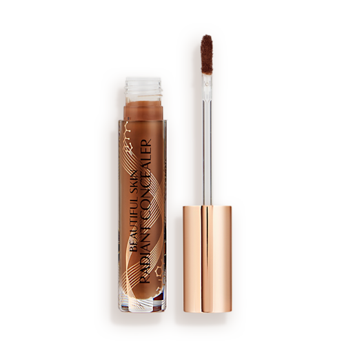 Beautiful Skin concealer in 16.5 open Dark brown radiant concealer in a glass tube with its gold-coloured lid with a doe-foot end next to it, and text on the tube that reads, 'Beautiful Skin Concealer'