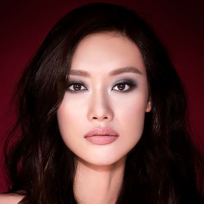 The Rock Chick look on fair tone model with brown eyes A fair-tone brunette model with brown eyes wearing smokey silvery eyeshadow with bronzed cheeks and glossy nude-peach lips.