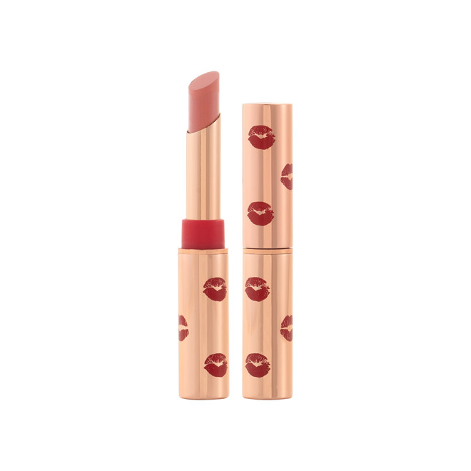 Two lipsticks, with and without lid, in a soft taupe shade with gold-coloured tubes with red-coloured kiss print all over the tubes. 