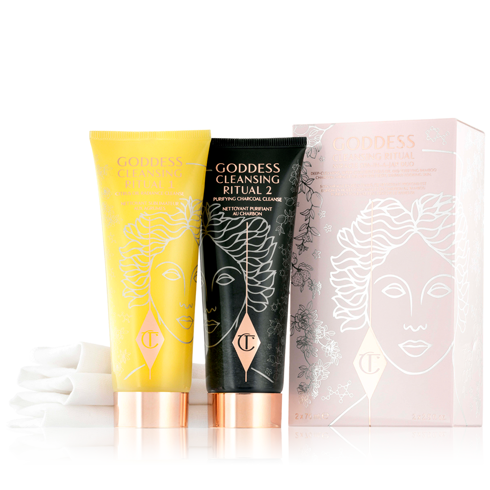 Goddess Cleansing Ritual Cleanser 1 & 2 Two facial cleansers, one in lemon-yellow packaging and the other in charcoal-black, with rose-gold coloured lids.