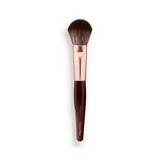 Synthetic Bronzer And Blush Brush A bronzer and blush brush with soft bristles and rose gold and dark crimson handle.