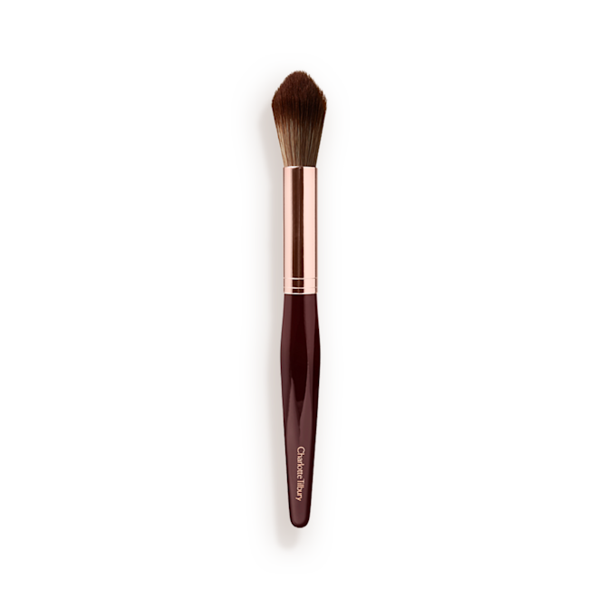 Synthetic Powder and Sculpt Brush A powder brush with soft bristles and the handle in a dark crimson and rose-gold colour scheme.