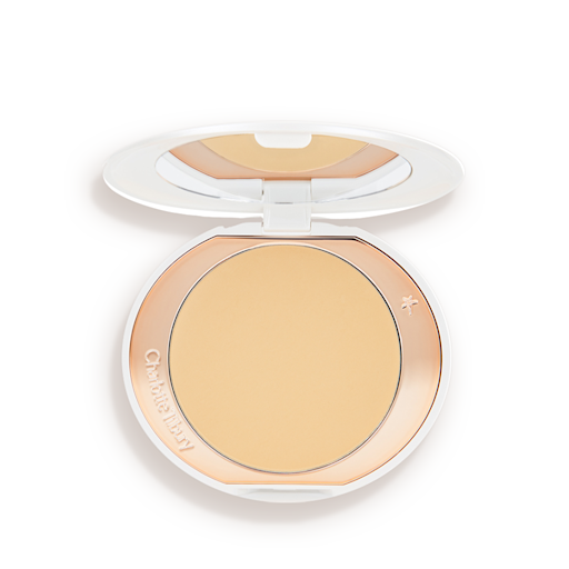 Airbrush Brightening Flawless Finish compact open An open, setting powder compact with a mirrored-lid and white and gold-coloured packaging.