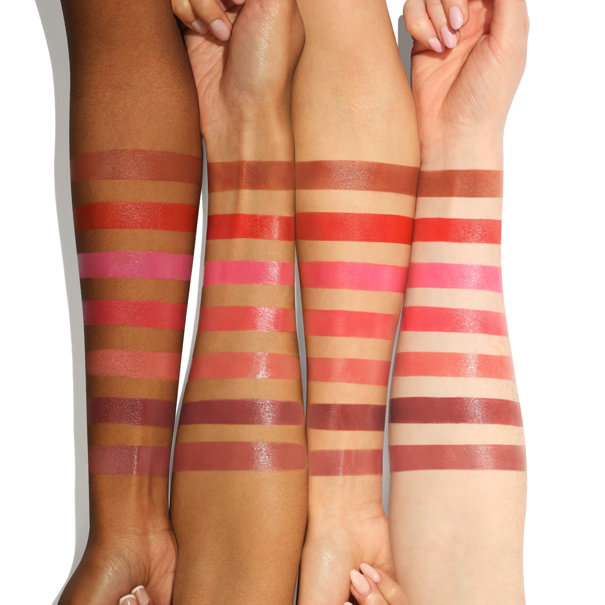 Lip + Cheek Tint all shades Arm swatches of all 7 shades of Charlotte's lip and cheek tint on fair, medium, tan and deep skin tones