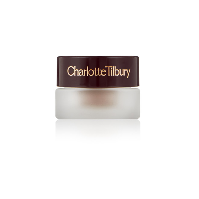A closed frosted glass pot with a cream eyeshadow in a nude cashmere shade with a matte finish with a dark brown lid with Charlotte Tilbury written on the lid in gold. 