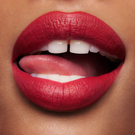 Medium skin tone model wearing Pizzazz lipstick