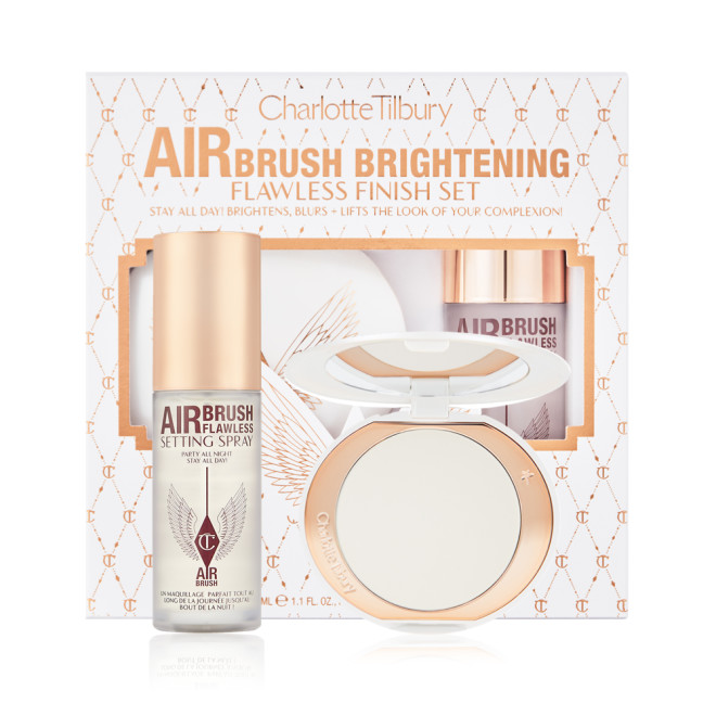 Setting spray in a clear bottle with a gold-coloured lid with a brightening setting powder compact in gold-packaging with a mirrored-lid along with a white and pink-coloured packaging box.