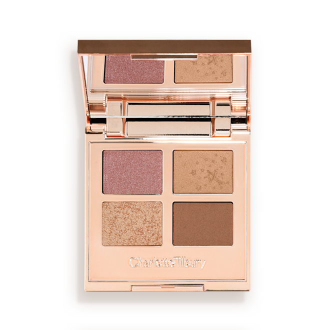 Luxury Palette of Pearls in Celestial Pearl open An open, mirrored-lid quad eyeshadow palette with soft earthy-tones in shades of pink, brown, and gold.