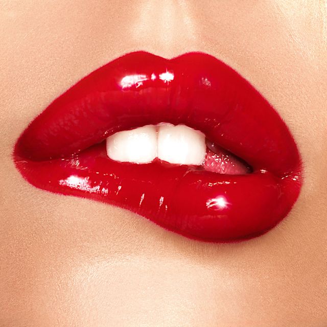 Glossy Red lip close up Model wearing a glossy red lip using Lip Lustre in Red Vixen