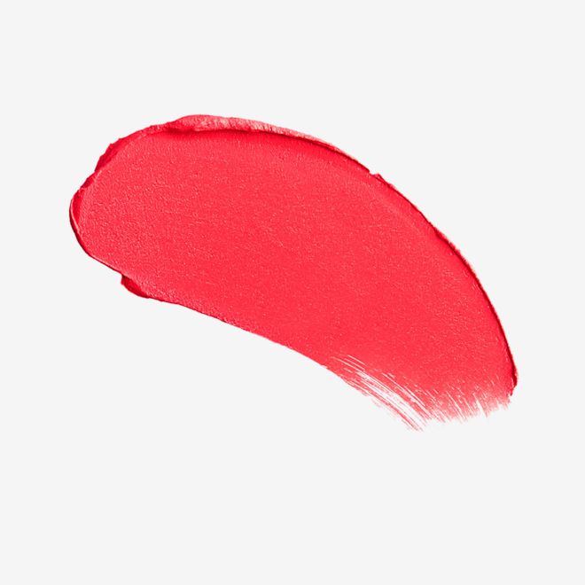 Matte Revolution lipstick in 1975 Red swatch Swatch of a classic, 70’s-inspired sunset red lipstick with a matte finish.