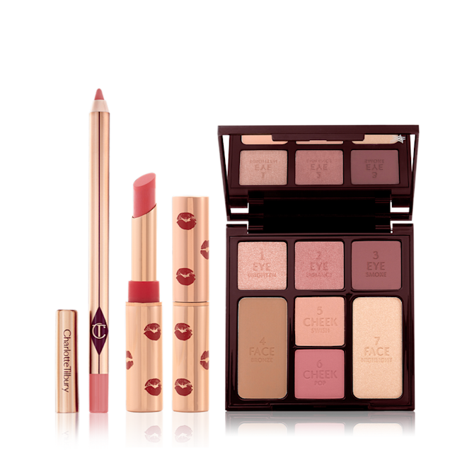 Mesmerising 5-minute Makeup Kit open An open lip liner pencil in a nude pink shade, open matte lipstick in a cherry-red shade, and an open face palette with a mirrored lid with nude brown and pink eyeshadows, two pink blushes, and a bronzer and highlighter.