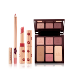 An open lip liner pencil in a nude pink shade, open matte lipstick in a cherry-red shade, and an open face palette with a mirrored lid with nude brown and pink eyeshadows, two pink blushes, and a bronzer and highlighter.