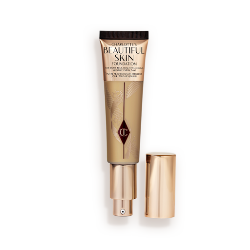 Beautiful Skin Foundation in Shade 7C open An open foundation wand in gold packaging with a pump dispenser and a medium-brown-coloured body to show the shade of the foundation inside.