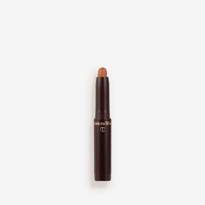 Quick & Easy Instant 5 Minute Kit Eyeshadow Stick in Golden glow open An open, cream eyeshadow wand in a golden bronze shimmer shade.