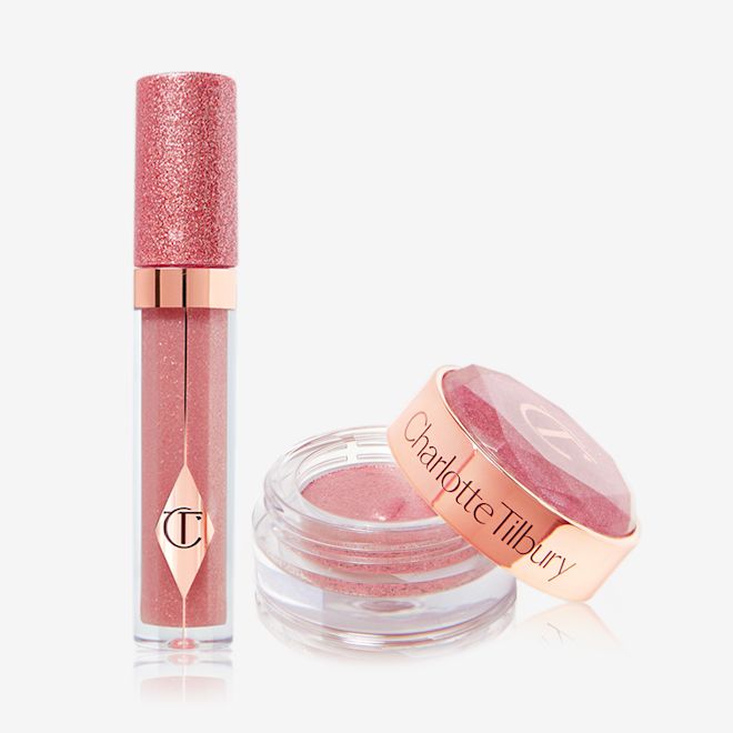 Jewel Pots and Lips in Pillow Talk displayed A shimmery nude-pink lip gloss in a glass tube with a glittery lid next to shimmery, cream eyeshadow in a nude-pink shade in a glass pot with its lid removed.