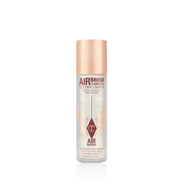 Airbrush Flawless Setting Spray lid on A setting spray in a clear bottle with a gold-coloured lid.