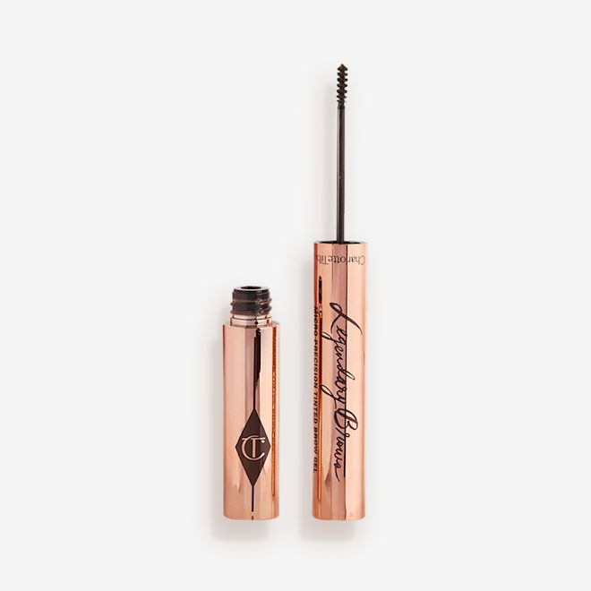 Legendary Brows Eyebrow gel in Dark Brown open Open, tinted brow gel in a dark brown shade with a thin brush for precision, and a shiny, gold-coloured tube.