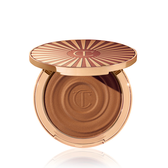 Open, cream bronzer compact in a medium-brown shade with gold-coloured packaging.