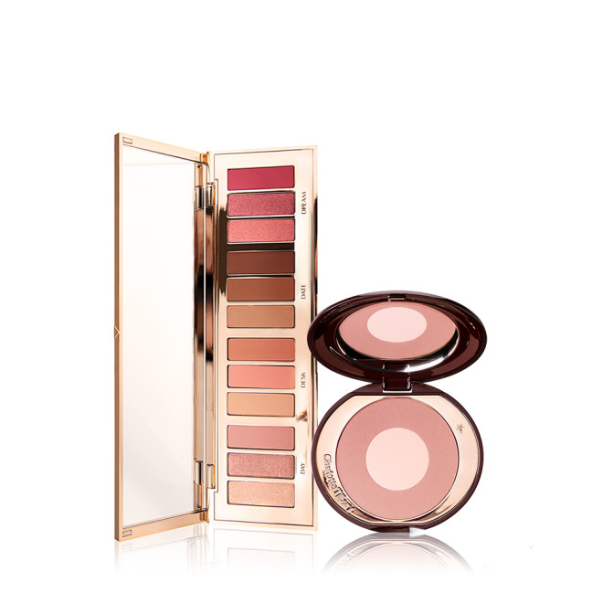 An open, mirrored-lid eyeshadow palette in pink, brown, peach, and golden shades with a two-tone,  mirrored-lid powder blush in pearlescent pink. 