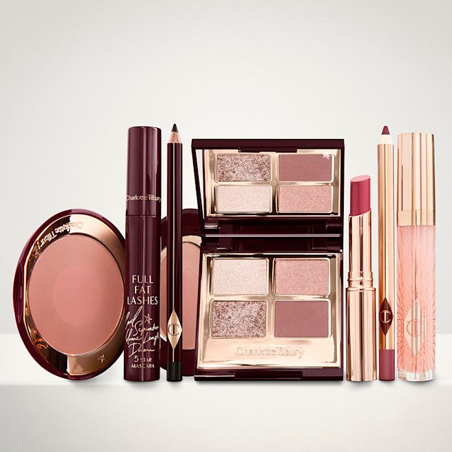 The Supermodel kit for Fair, Light and Medium tones displayed An open two-tone blush in cool-toned brown and warm pink with a mascara, eyeliner pencil, quad eyeshadow palette with shimmery and matte brown and golden shades, an open lipstick in nude red, lip liner pencil in maroon and a lip gloss in nude pink.