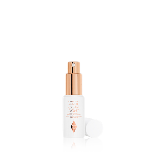 Magic Cream Light Travel Size lid removed A travel-size face cream in a white and gold-themed clear bottle with a pump dispenser and a white-coloured lid.