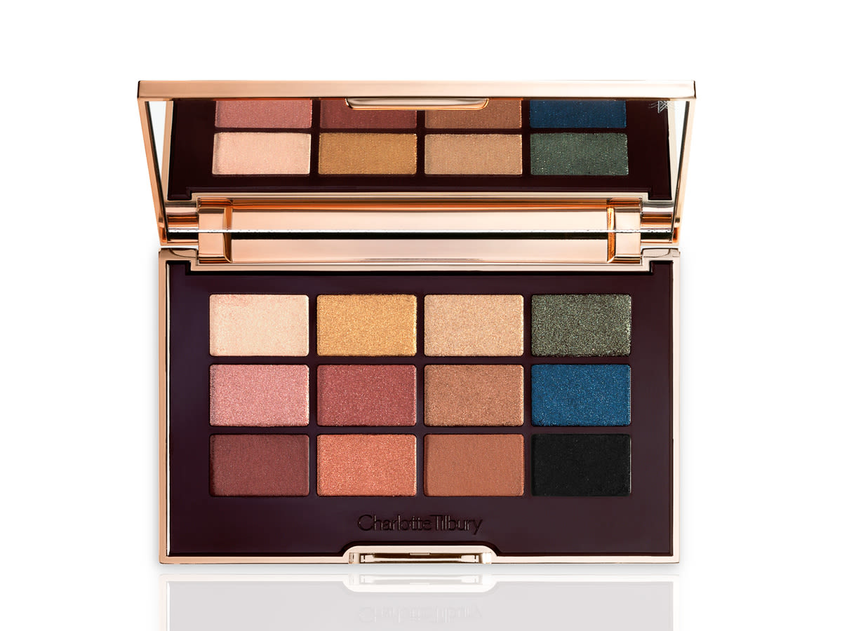 The Icons Palette open An open, mirrored-lid eyeshadow palette with nude brown, green, blue, black, gold, and pink shades.