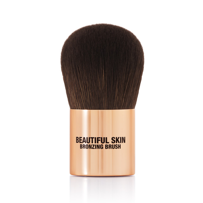 A bronzer brush with soft, dark brown synthetic bristles and a golden-coloured handle, perfect for both cream and powder bronzers. 