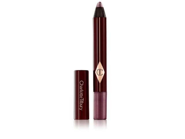 Colour Chameleon in Amethyst Aphrodisiac lid removed An open, chubby eyeshadow stick in shimmery purple colour with its lid next to it.