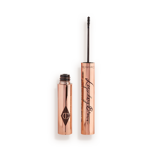 Legendary Brows Eyebrow gel in Black Brown open Open, tinted brow gel in a black-brown shade with a thin brush for precision, and a shiny, gold-coloured tube.