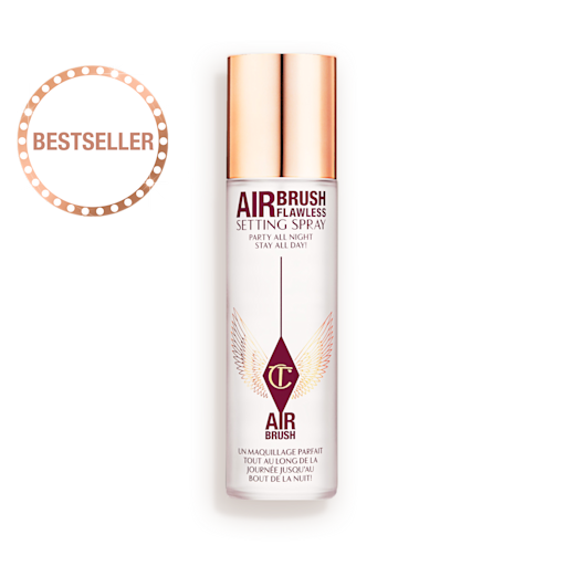 Airbrush Flawless Setting Spray lid removed An open, setting spray in a clear bottle with a gold-coloured lid placed next to it.