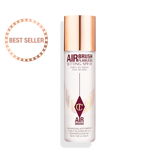 Airbrush Flawless Setting Spray lid removed An open, setting spray in a clear bottle with a gold-coloured lid placed next to it.