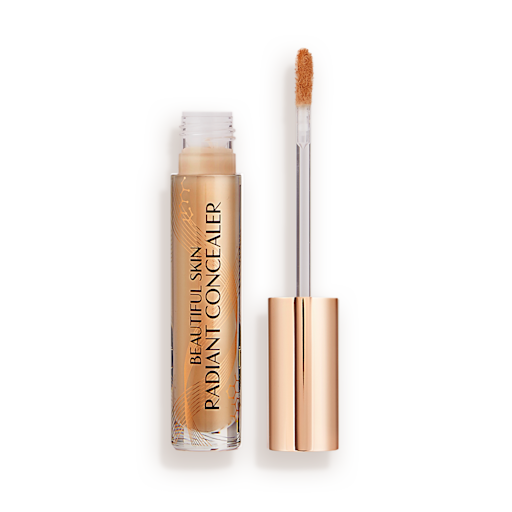 Beautiful Skin Radiant in Concealer in 11 lid removed Radiant concealer in a glass tube with its doe-foot applicator next to it with a gold-coloured handle.