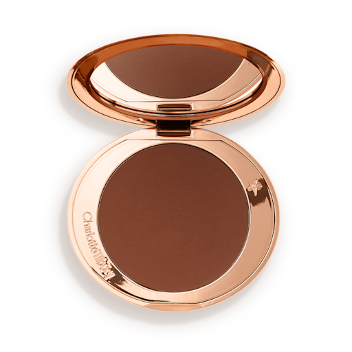 Airbrush Bronzer in Deep open An open mirrored-lid bronzer compact in a dark brown shade.