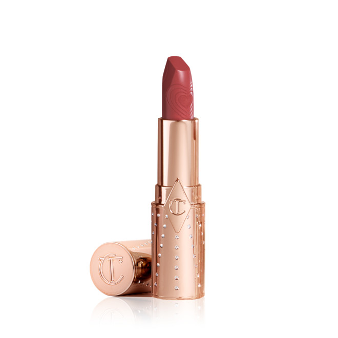 An open, satin finish lipstick in a rose pink shade in a gold-coloured tube with its lid next to it.