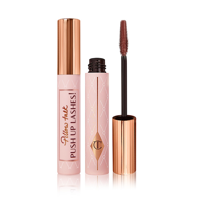 Two tubes of mascara, one with a lid on and one without, in a chocolate-brown-colour with a pink-coloured tube with a gold-coloured lid. 