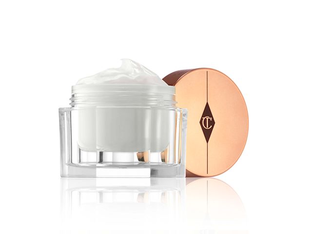 Magic Cream open An open, pearly-white face cream in a glass jar with a golden-coloured lid.
