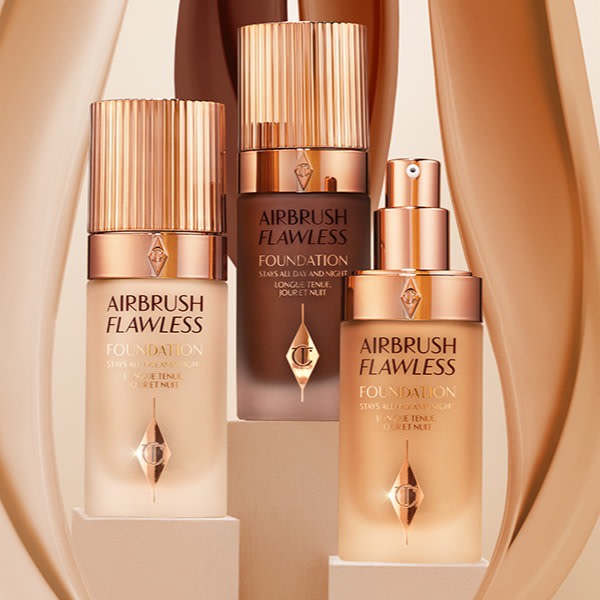 Three foundations in light, medium, and deep tones in frosted glass bottles in rose-gold and clear colour scheme. 