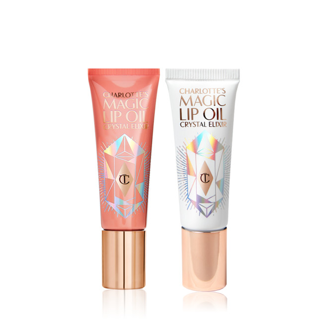 two closed lip oils in a white-coloured tube with a gold-coloured lid and coral-coloured tube with gold-coloured lid. 
