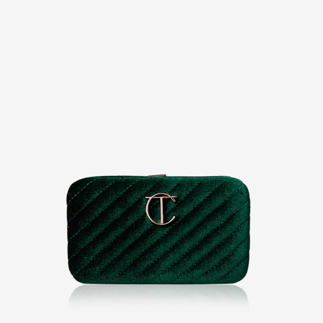 Charlotte's Hollywood Mini Brush Set closed A closed makeup bag in a bottle green colour with the CT logo in the middle in golden.