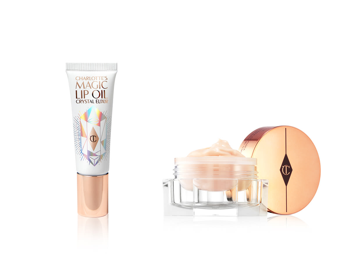 Magic Lip Oil Crystal Elixir and Magic Eye Rescue` Lip oil in a white coloured tube with a beige coloured cream in a glass jar with the lid beside it.