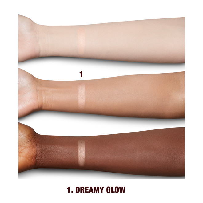 Fair, tan, and deep-tone arms with swatch of a glowy light rose-gold powder highlighter. 