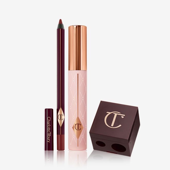 Pillow Talk Dreamy Defined Eyes Kit A berry-brown eyeliner pencil, black mascara with nude pink bottle and gold-coloured lid, and a dark crimson-coloured pencil and eyeliner sharpener.