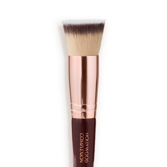 Synthetic Hollywood Complexion Brush close-up Close-up of a face blending contour brush with fawn, dark brown, and white-coloured bristles with rose-gold and dark crimson handle.