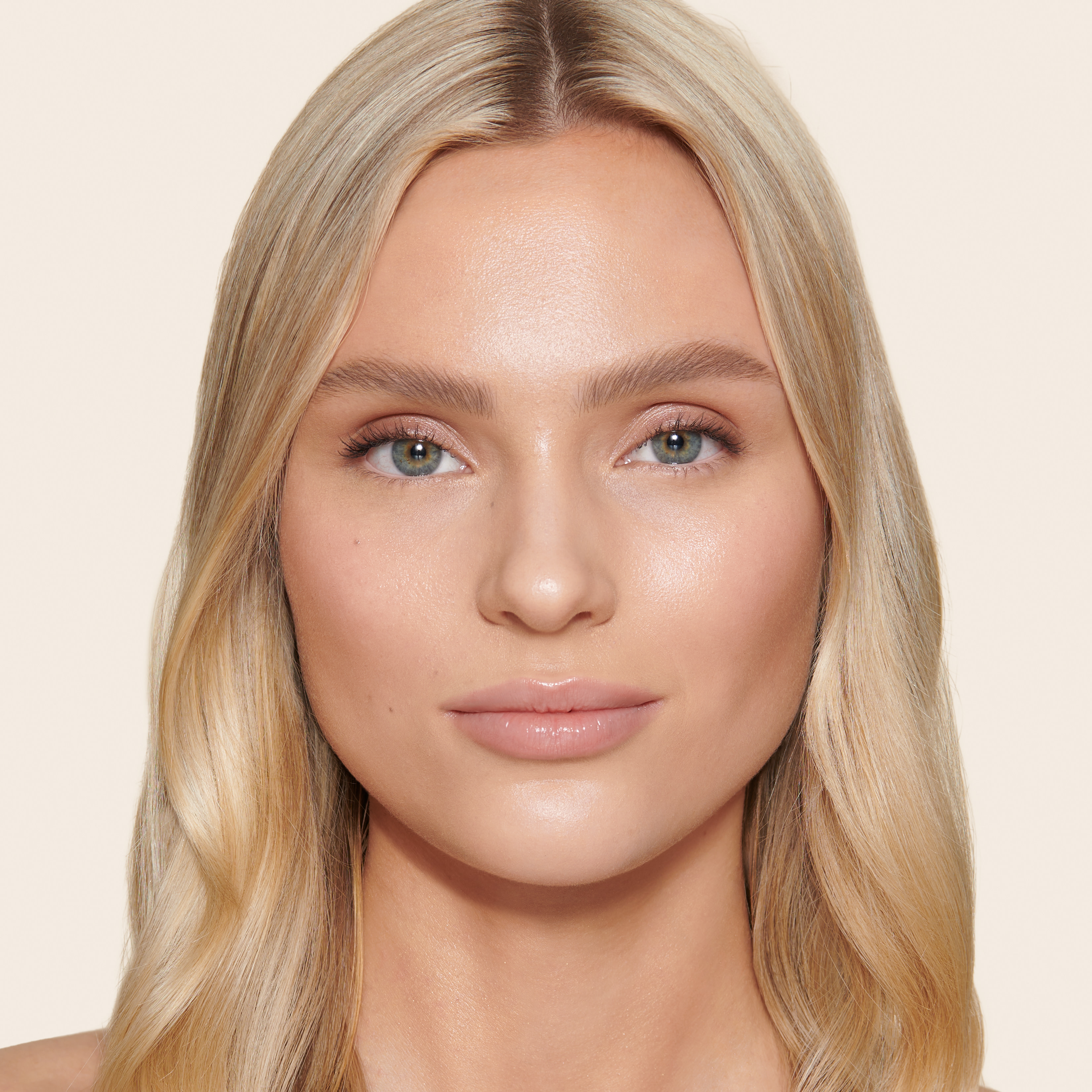 Model wearing a natural makeup look using Unisex Healthy Glow tinted moisturiser