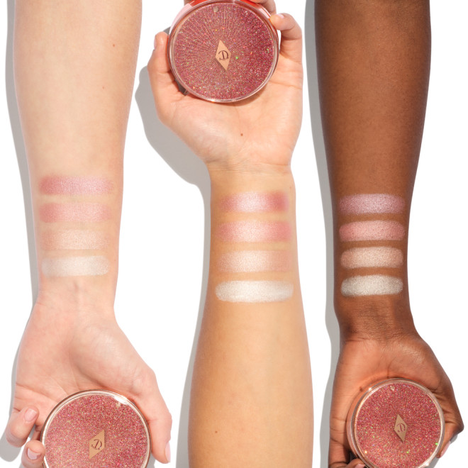 Deep, tan, and fair-tone arms with swatches of four powder highlighters for cool-tone complexions in light pink, peachy-pink, champagne, and beige-gold.