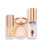 Hollywood Flawless Filter, Airbrush Flawless Finish, and Setting Spray Travel Size Kit Travel-size kit that includes a glowy primer in a glass bottle with gold-coloured lid, face powder compact in a light shade with a mirrored-lid in gold-coloured packaging, and setting spray in a clear bottle with gold-coloured lid.